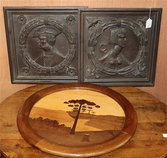 Two figurative carved panels and a circular parquetry panel Diam. 60cm